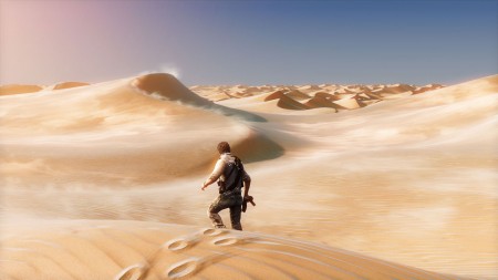 Nathan Drake walks away from the camera in a seemingly endless desert